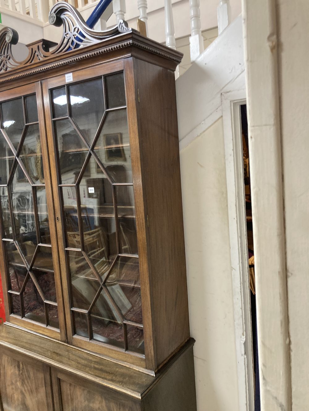 A George III style mahogany two door glass china display cabinet, with two panelled doors beneath, width 110cm depth 47cm height 220cm